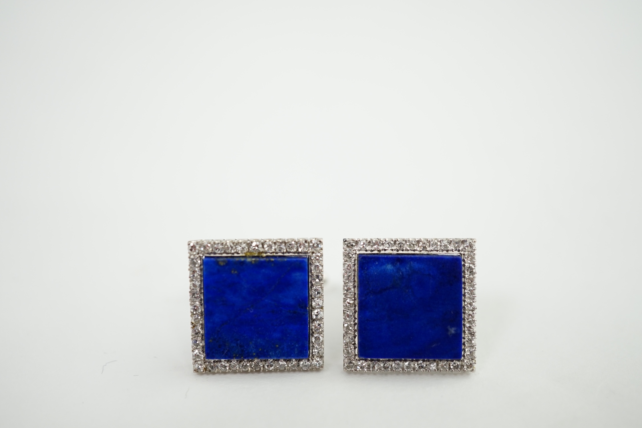 A pair of 18K white gold, lapis lazuli and diamond set tablet cufflinks, each lapis stone surrounded by forty claw set diamonds